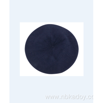 A MATCHING ACRYLIC BERET IN DARK BLUE